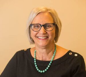 Image of Ellen Goldring in black shirt with blond hair
