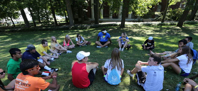 students outside sitting in a circle