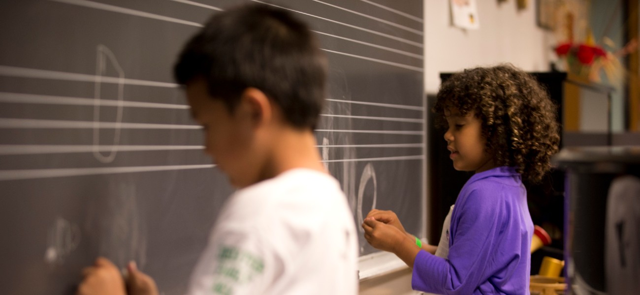 children writing on blackboard