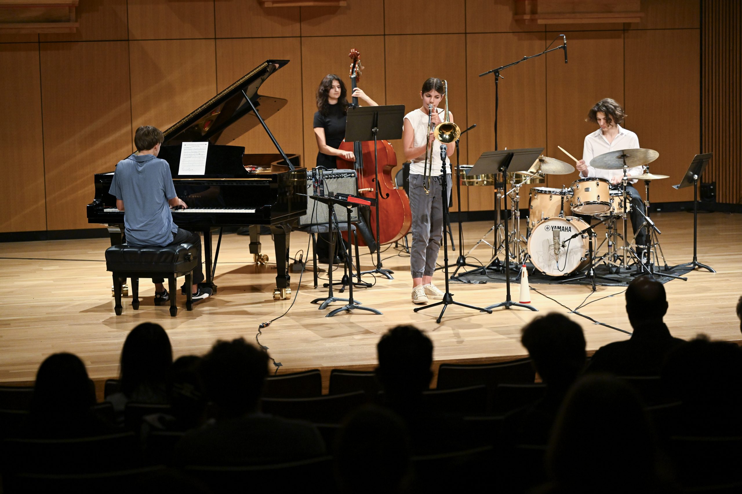 A jazz combo playing together on a stage