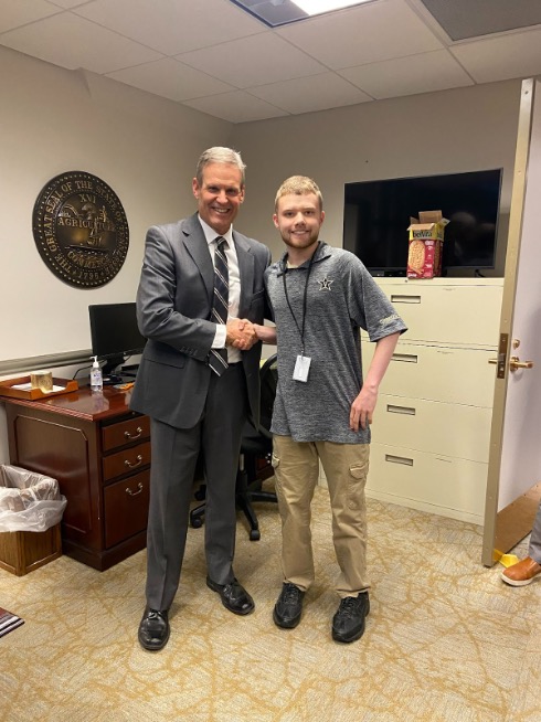 Student shaking hands with Governor