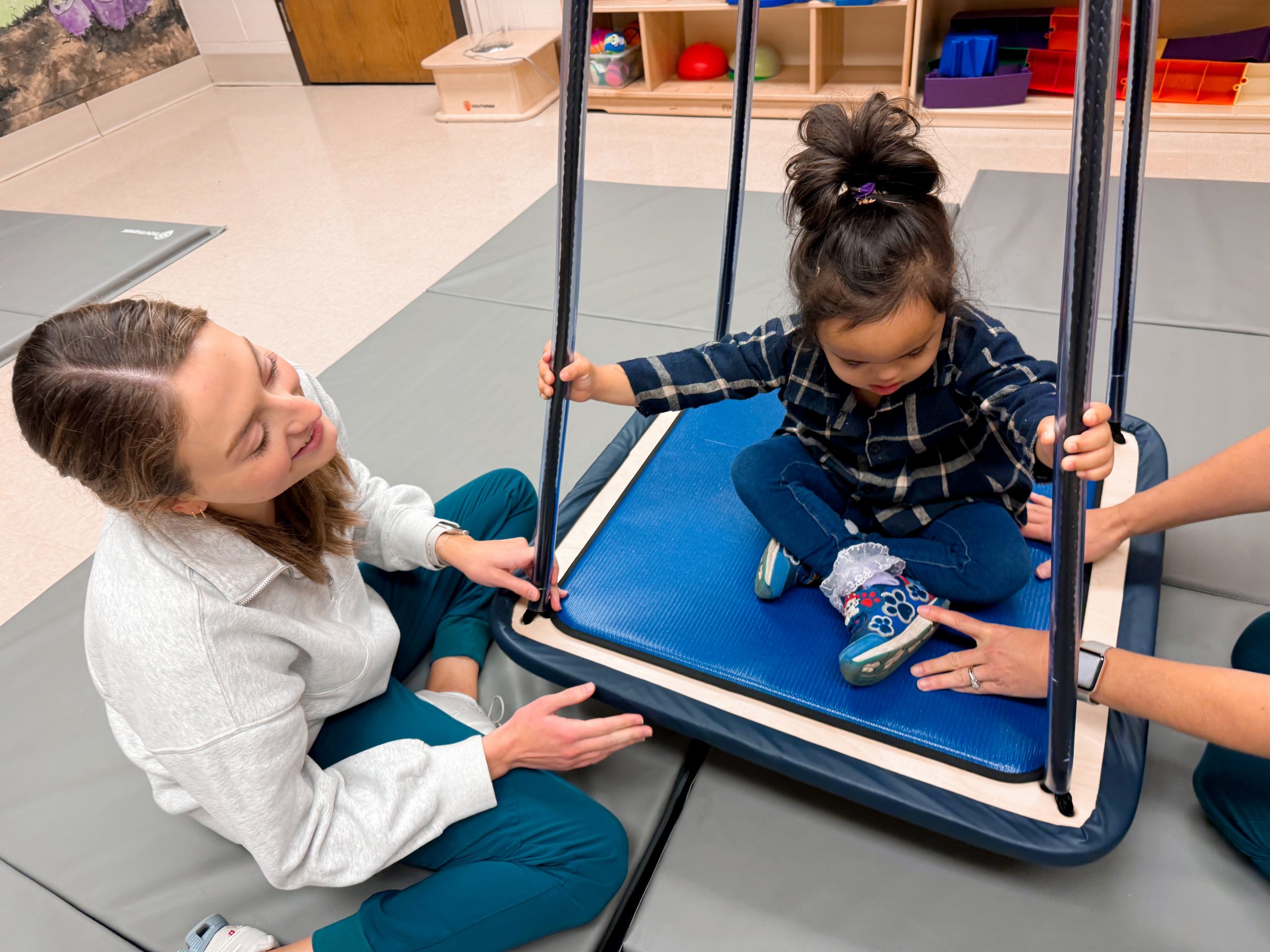 The Susan Gray School - adult with child on swing