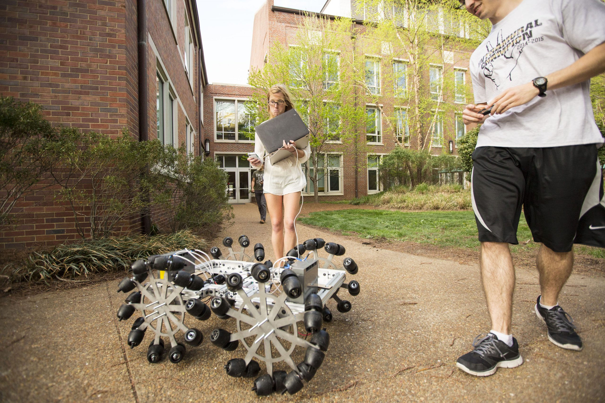 students with a robot on campus
