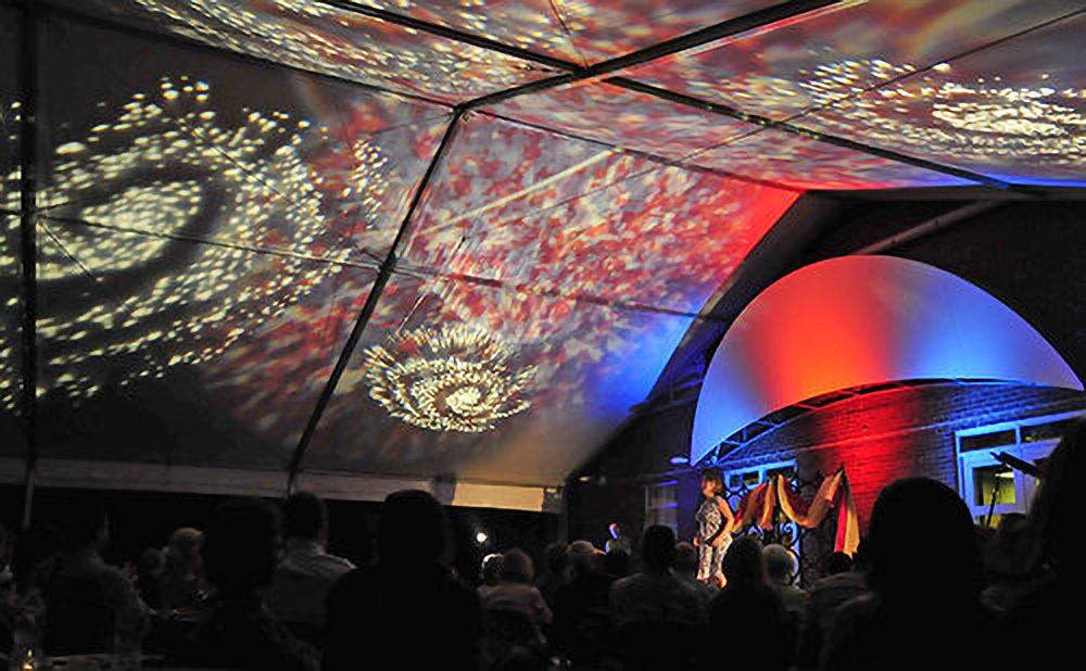 Evening Opera on the Mountain performance under a tent with colorful lighting at Vanderbilt Dyer Observatory.