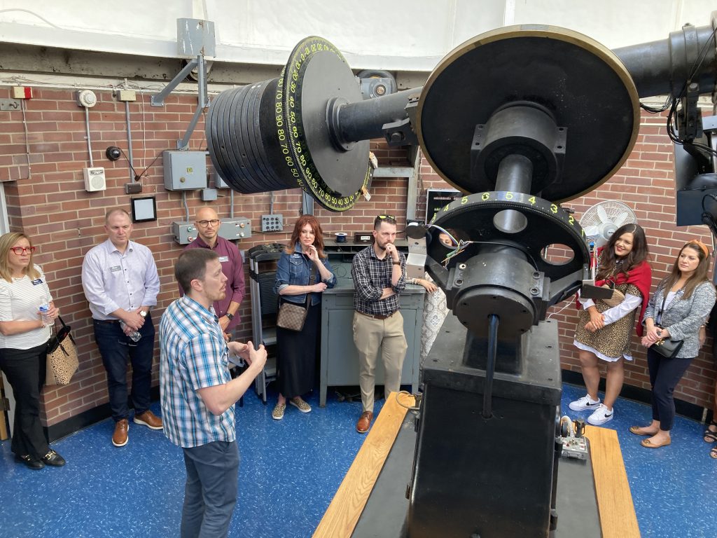 Dr. Billy Teets discusses the Seyfert Telescope with the guests surrounding it