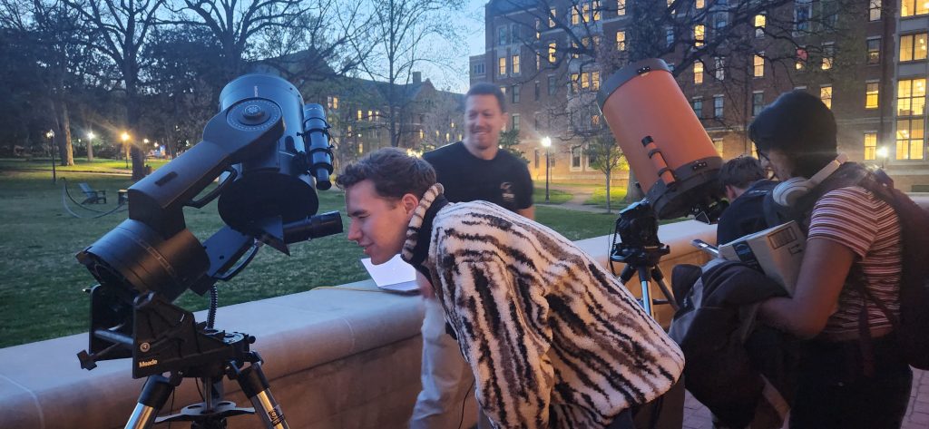Students view the Moon and Jupiter through telescopes