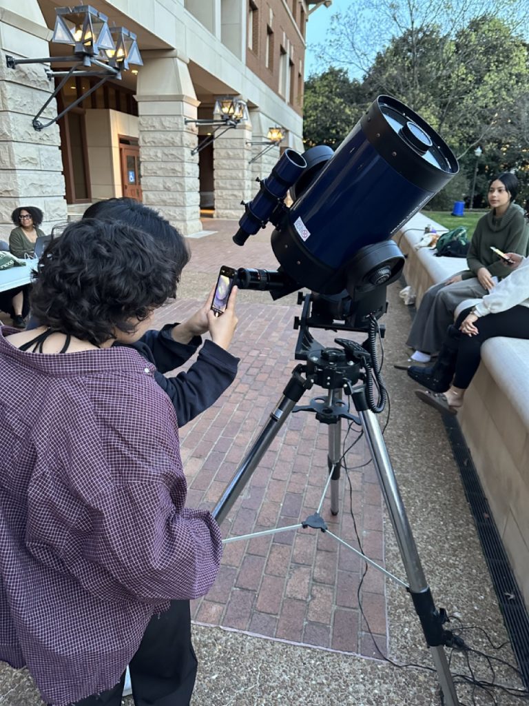 Students take a picture of the Moon through the telescope