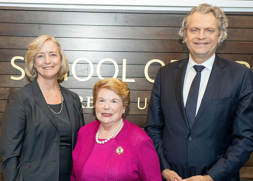 Provost Wente, Dean Linda Norman and Chancellor Daniel Dermeier pose in front of a wood wall that says School of Nursing