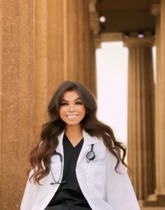 person in lab coat smiling