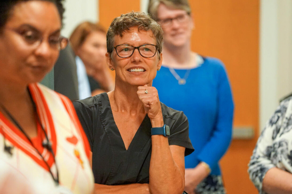 people watching a talk, smiling