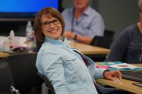 person sitting in a chair, smiling