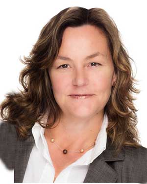 Headshot of Kelly Aldrich in a white blouse and gray blazer