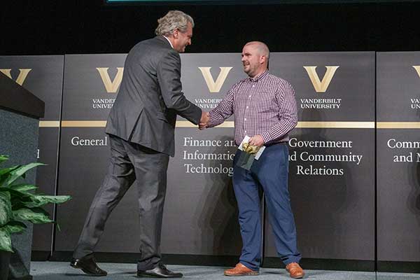 Chanceller shakes hand of Tim Groves