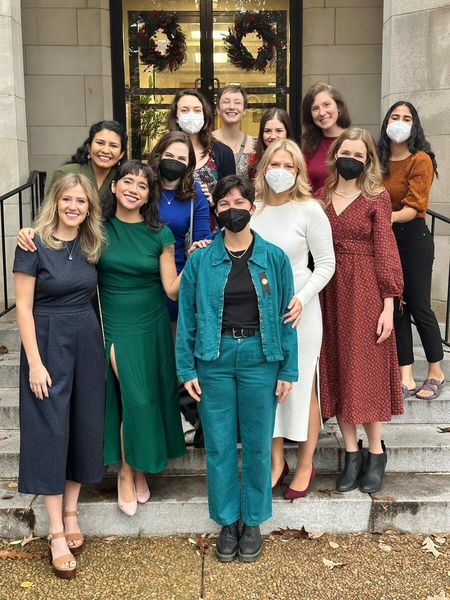 group of people smiling on steps