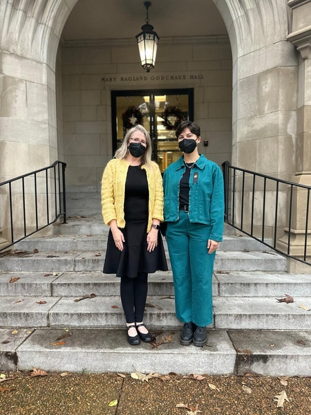 two people in masks on stairs