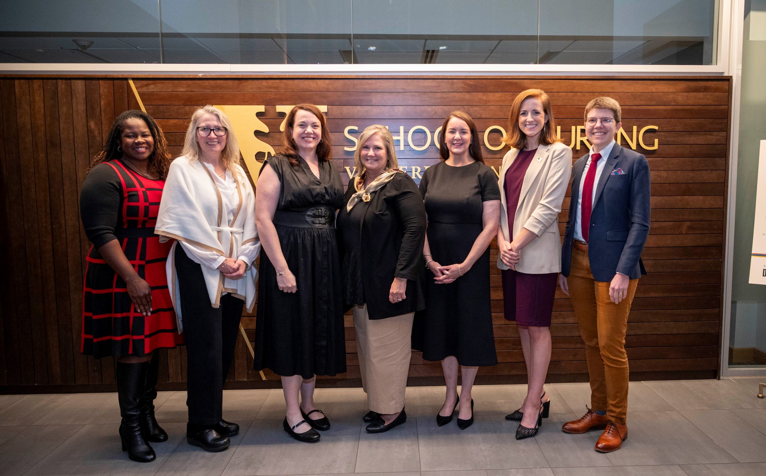 Seven people look at the camera and smile in the VUSN atrium.