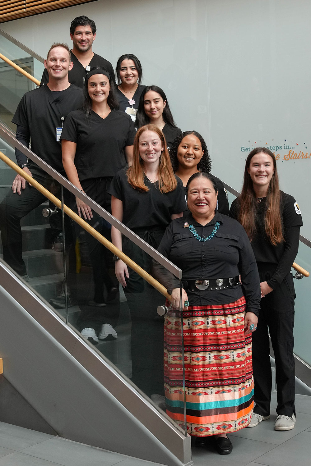 Students on a staircase with faculty member