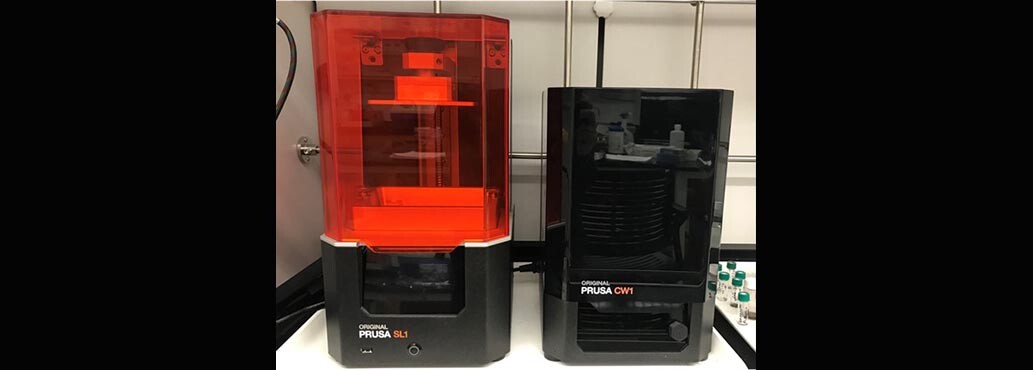 Prusa SL1 3D printer (left) and Prusa CW1 curing and washing station (right)