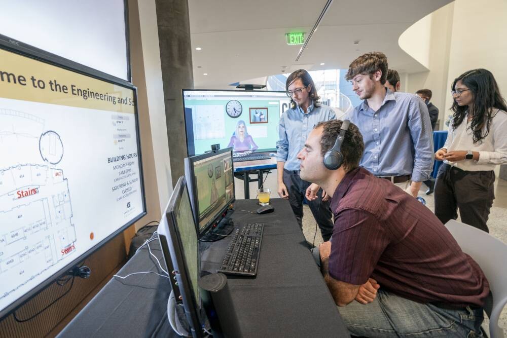Dan Burger demonstrates FCAI workforce readiness software to visitors at the center.