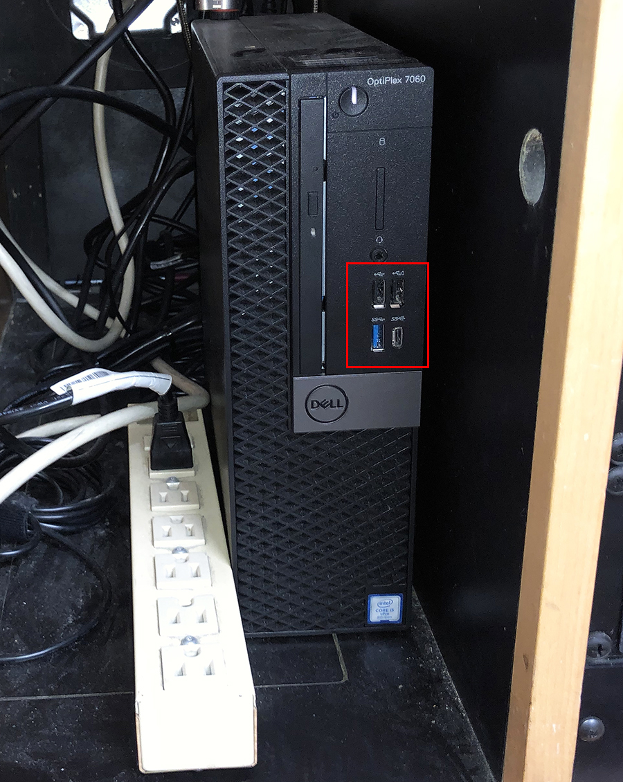 Photo of the Dell PC located inside the podium. Four ports are indicated with a red box.