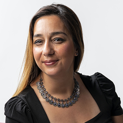 Headshot of Houra Merrikh wearing a necklace and black dress.