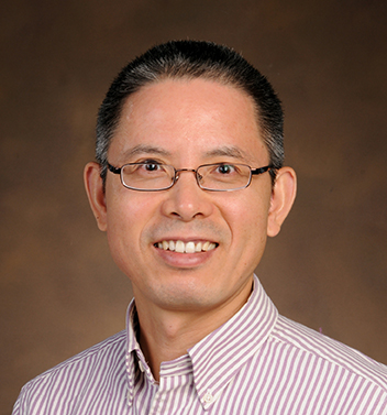 Headshot of Wenbiao Chen wearing eye-glasses and a striped shirt.