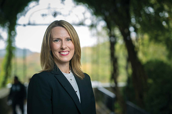 Terrah Akard stands in front of trees and plants