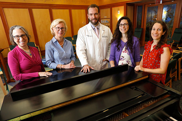 Vanderbilt researchers posed around a piano