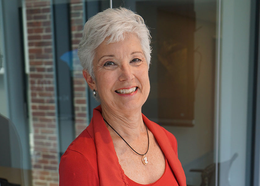 School of Nursing professor Susie Adams standing in front of glass walled conference room