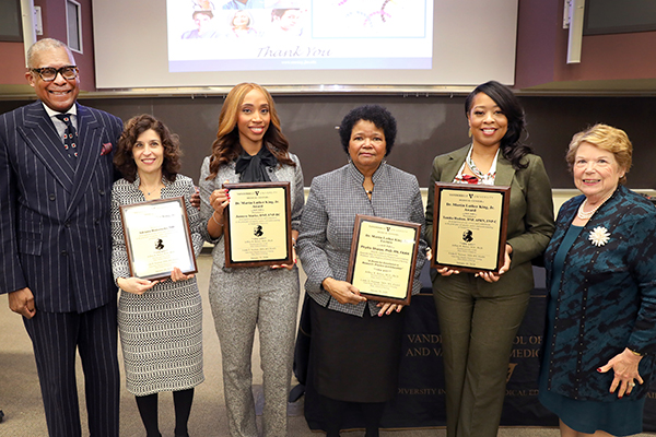 Vanderbilt Martin Luther King Jr. Award winners and guest speaker Phyllis Sharps hold plaques, while Dr. Andre Churchwell and Dean Linda Norman flank them