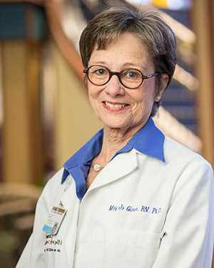 Vanderbilt nurse researcher Mary Jo Gilmer in white coat in lobby of Monroe Carell Children's Hospital