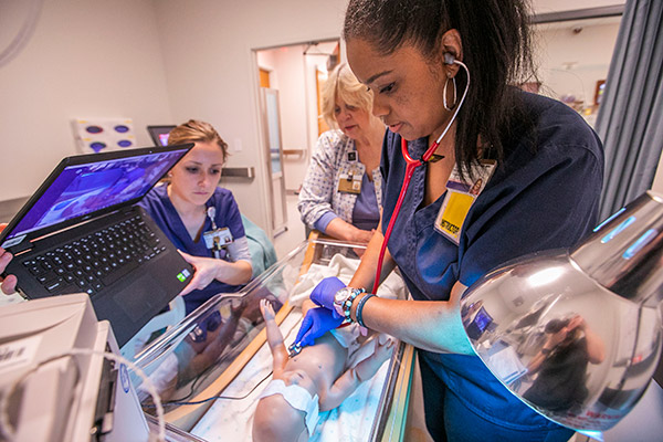 3 Vanderbilt Nursing instructors interact with students via video conferencing in the school's simulation lab