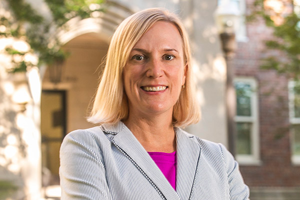 Vanderbilt nursing faculty Kate Clouse stands in front of the entrance to Godchaux Hall