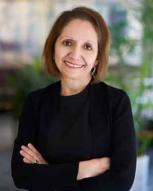 Antonia Villarruel standing in front of greenery