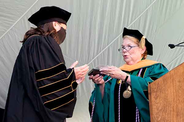 DNP graduate Rebecca Silver accepts the VUSN Founder's Medel from Dean Linda Norman