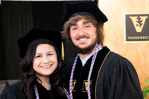 DNP graduates Emily Brignola and Josh Waddell in front of the VU podium