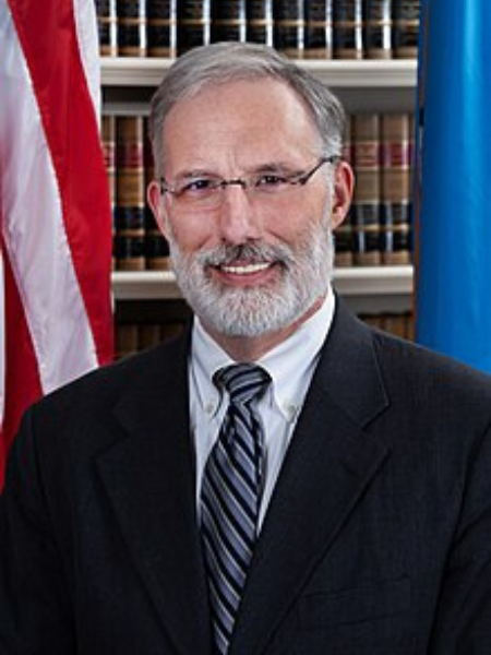 J. Travis Laster