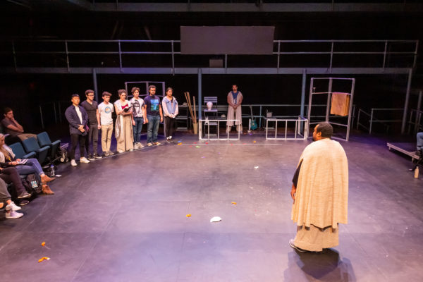 Students participating onstage in workshop production of Antigone