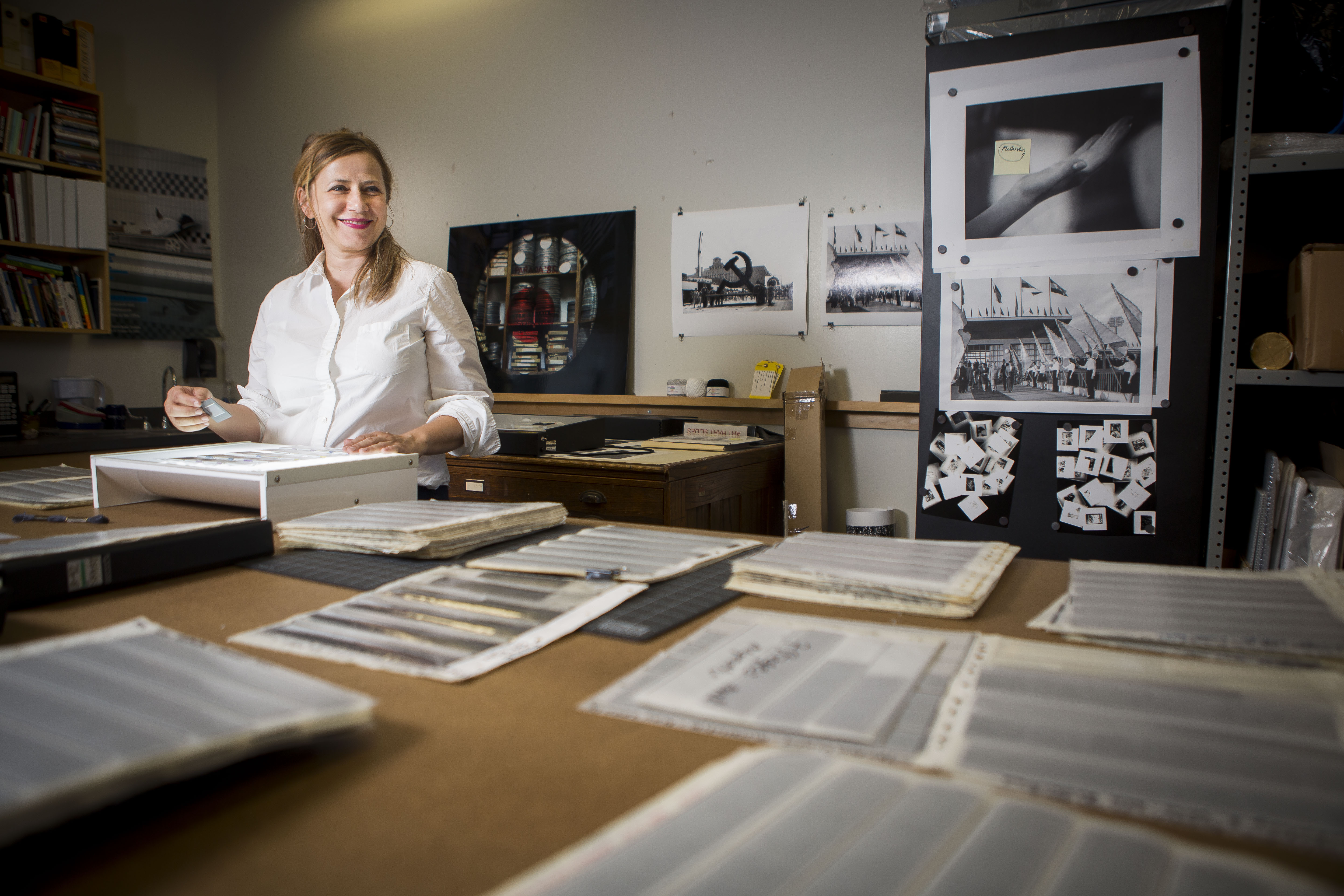 Vesna Pavlović standing at table surrounded by photos and documents