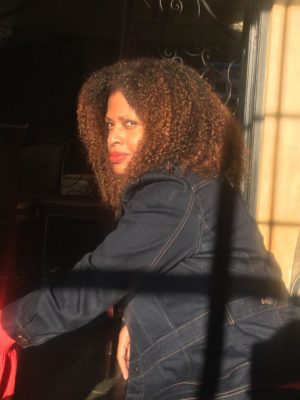 photo of Tracy Sharpley-Whiting sitting in an outdoor cafe