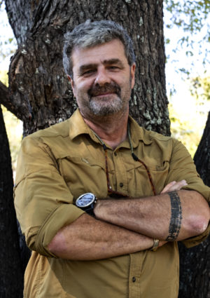 photo of Norbert Ross standing in front of a tree