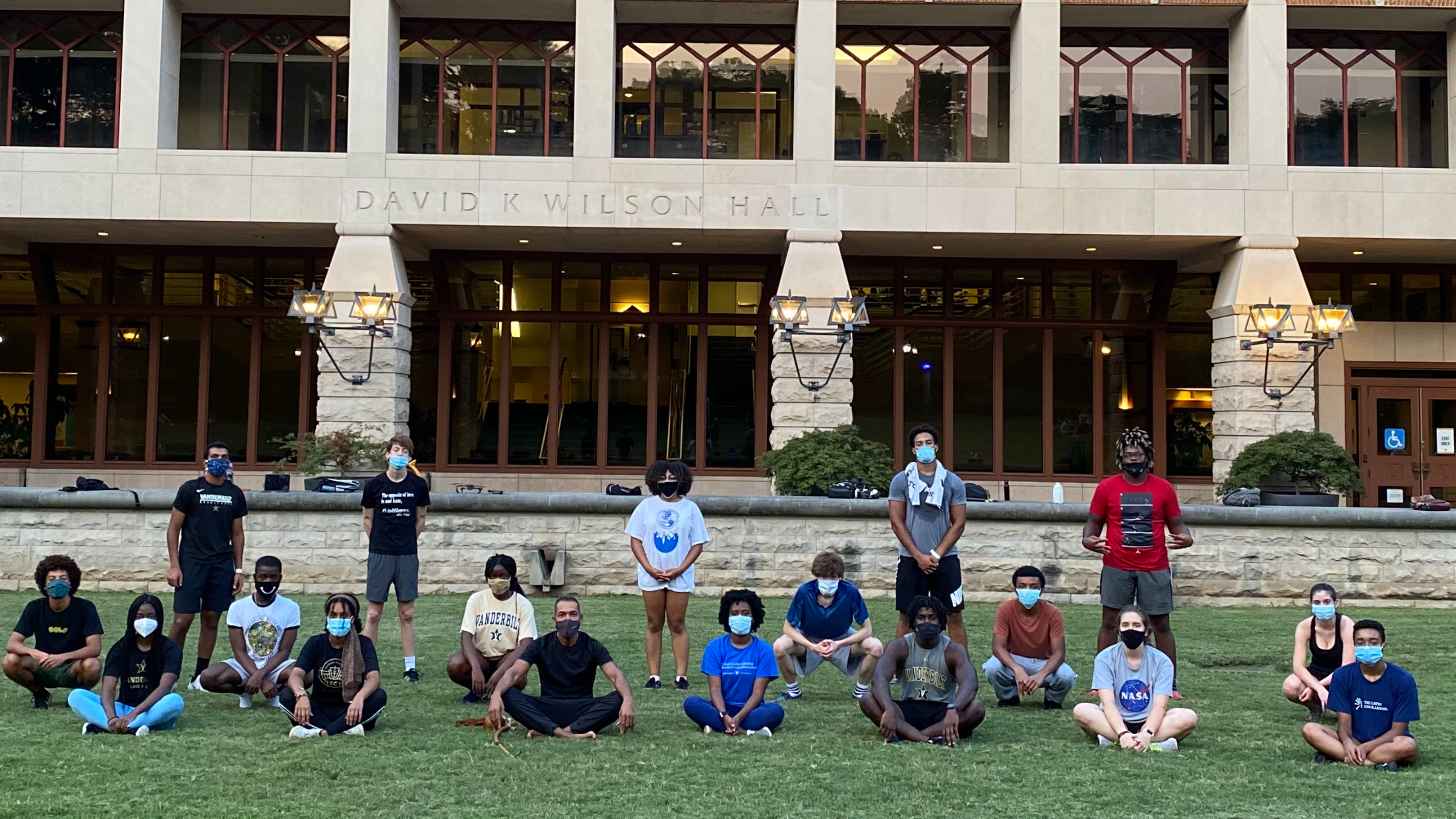 Gilman Whiting and students from his capoeira class pose, masked and socially distanced, on lawn in front of Wilson Hall