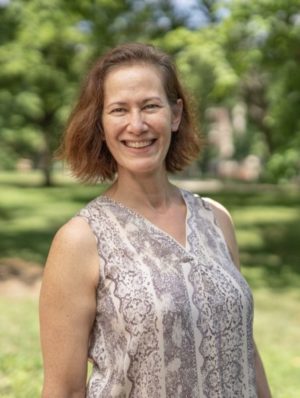 Elizabeth Meadows standing outside on the Vanderbilt campus with trees and grass in background