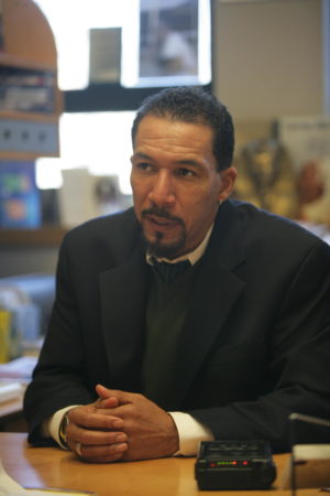 Gilman Whiting sitting at a desk in his office