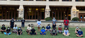 Gilman Whiting and students from his capoeira class pose, masked and socially distanced, on lawn in front of Wilson Hall