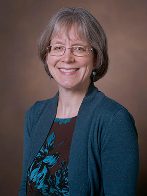 Head shot of Katherine Friedman against a brown background