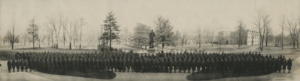 historic black-and-white photo of uniformed Vanderbilt World War One cadets standing in front of Cornelius Vanderbilt statue with trees in background