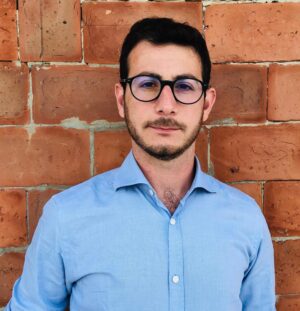 Emanuele Costa standing in front of a brick wall