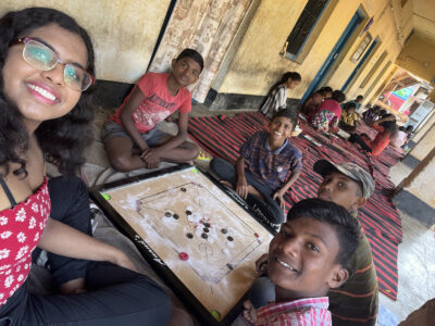 Woman and children playing a board game