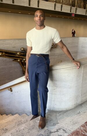 man standing at top of stairs